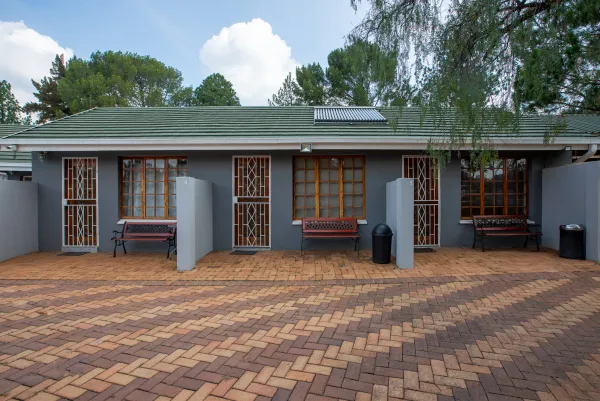 Room exterior with benches and warm window light