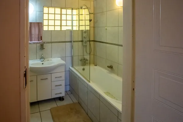 Room 3 — En-suite bathroom with bath and glass shower screen